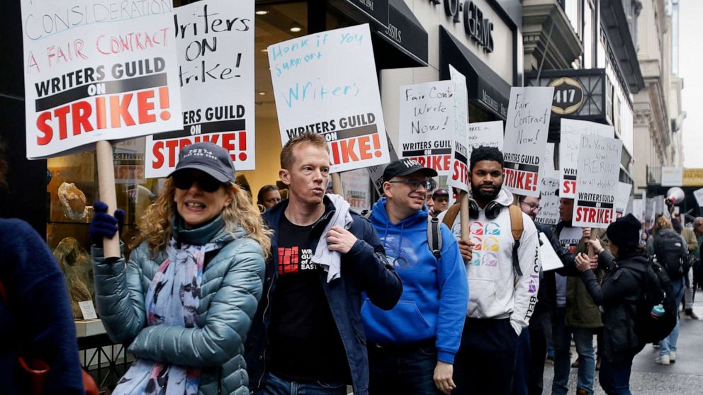 PHOTO: Demonstrators carry signs during a screenwriter's strike in New York City, May 2, 2023.