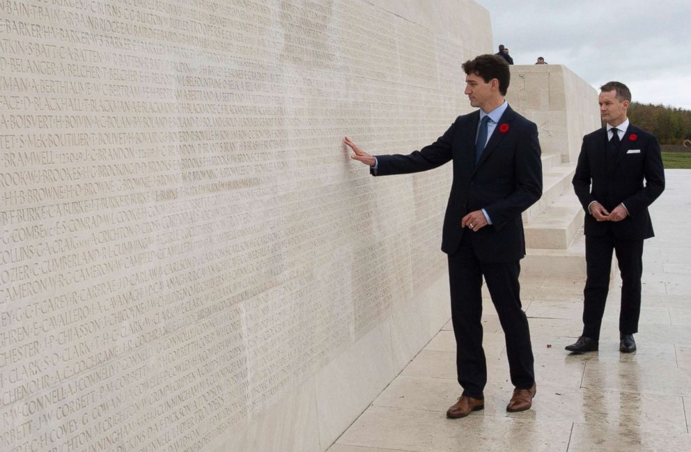 PHOTO: Canada's Minister of Veterans Affairs Seamus O'Regan looks on as Canadian Prime Minister Justin Trudeau touches the names of fallen soldiers engraved in the Canadian National Vimy Memorial, Nov. 10, 2018, at Vimy Ridge, in France. 