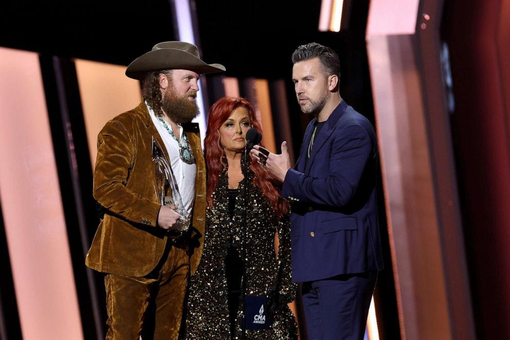 PHOTO: John Osborne, Wynonna Judd and T.J. Osborne speak onstage at The 56th Annual CMA Awards at Bridgestone Arena on Nov. 9, 2022, in Nashville, Tenn.