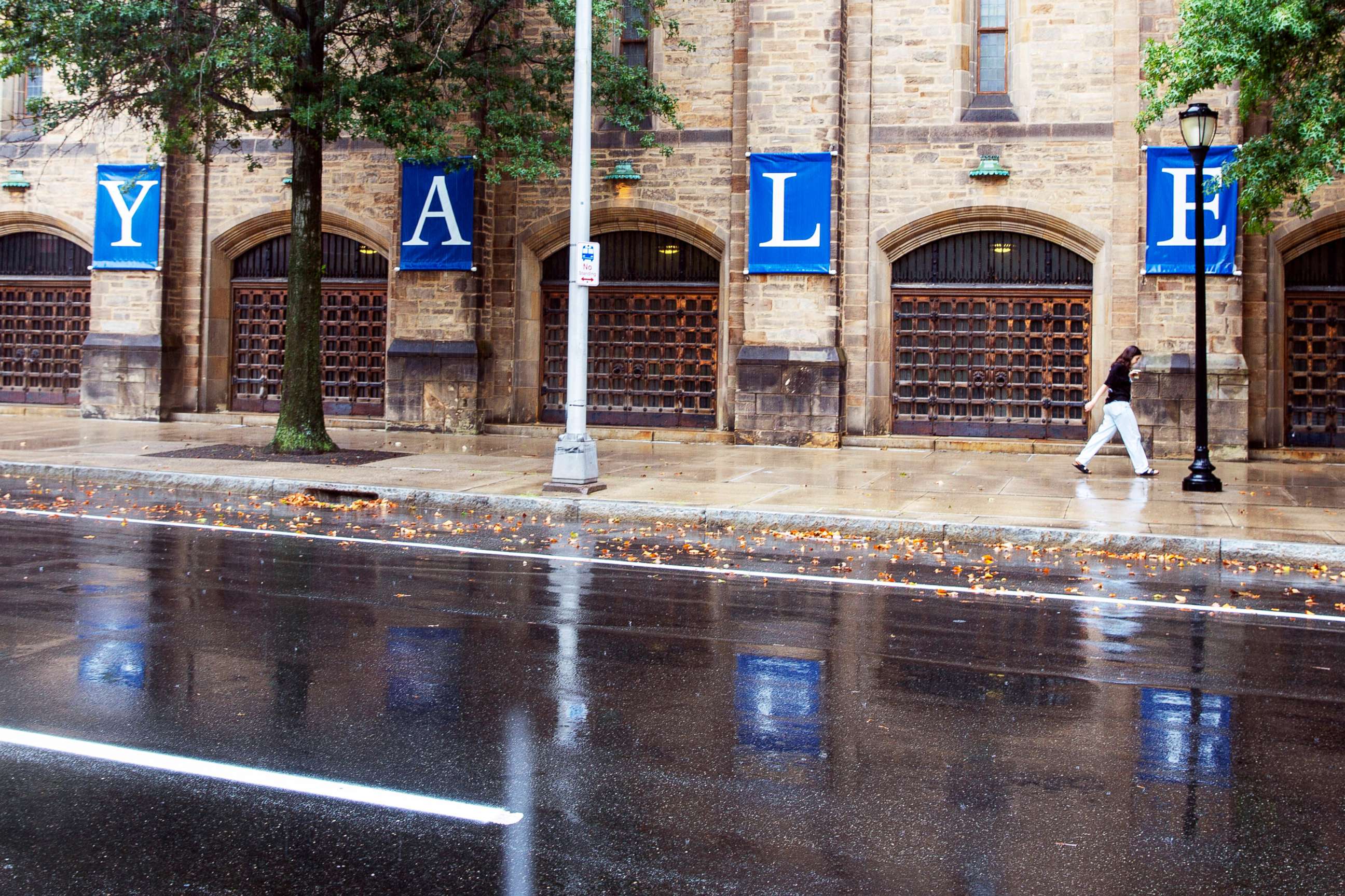 PHOTO: A person walks by a Yale sign on the Yale University campus, Aug. 22, 2021, in New Haven, Conn.