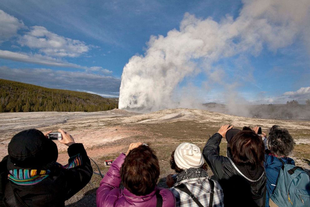 PHOTO: Tourists photograph Old Faithful erupting on schedule late in the afternoon in Yellowstone National Park, Wyo., May 21, 2011.