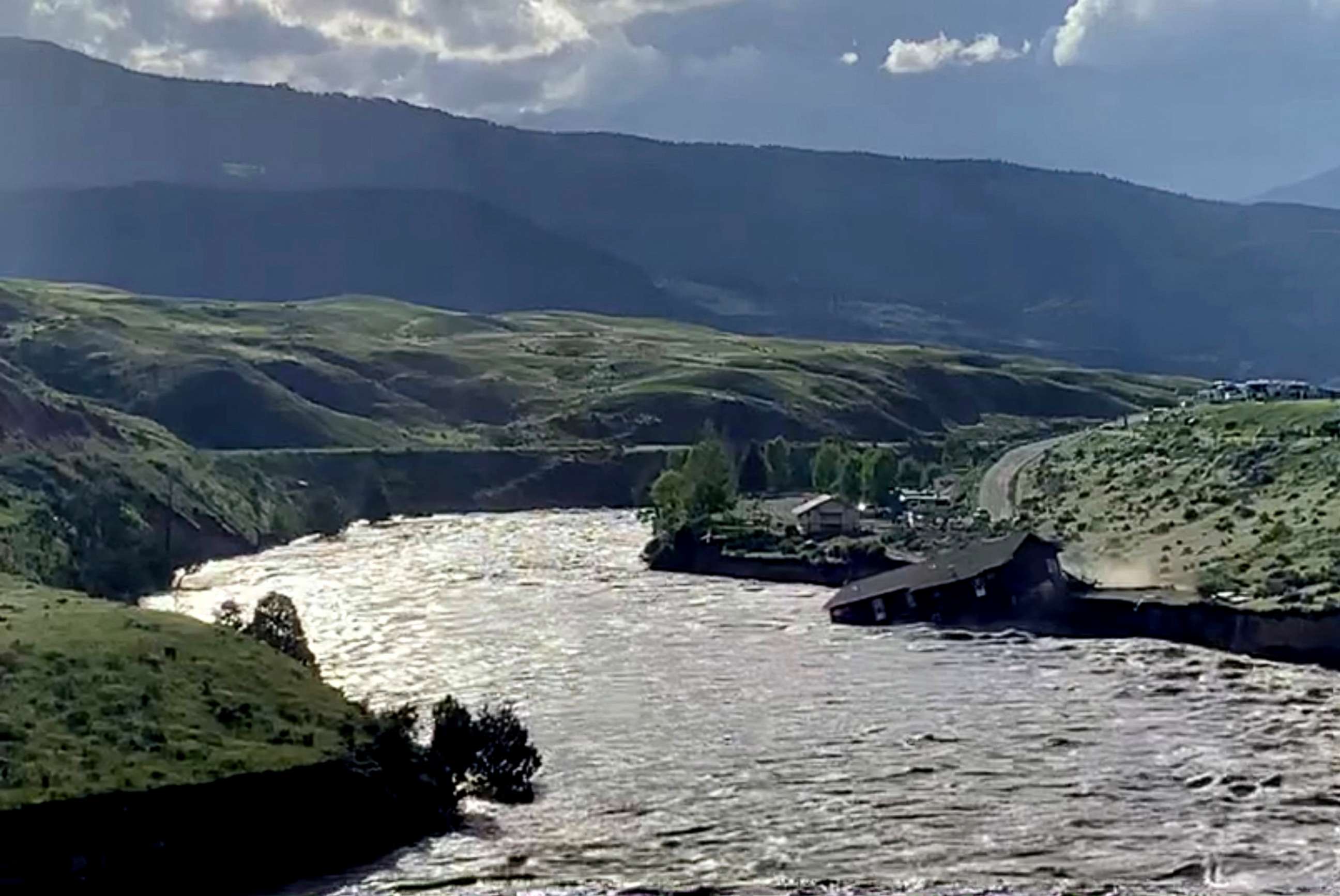 PHOTO: A house falls into the Yellowstone river due to flooding in Gardiner, Mont., June 13, 2022 in this screen grab obtained from a social media video.