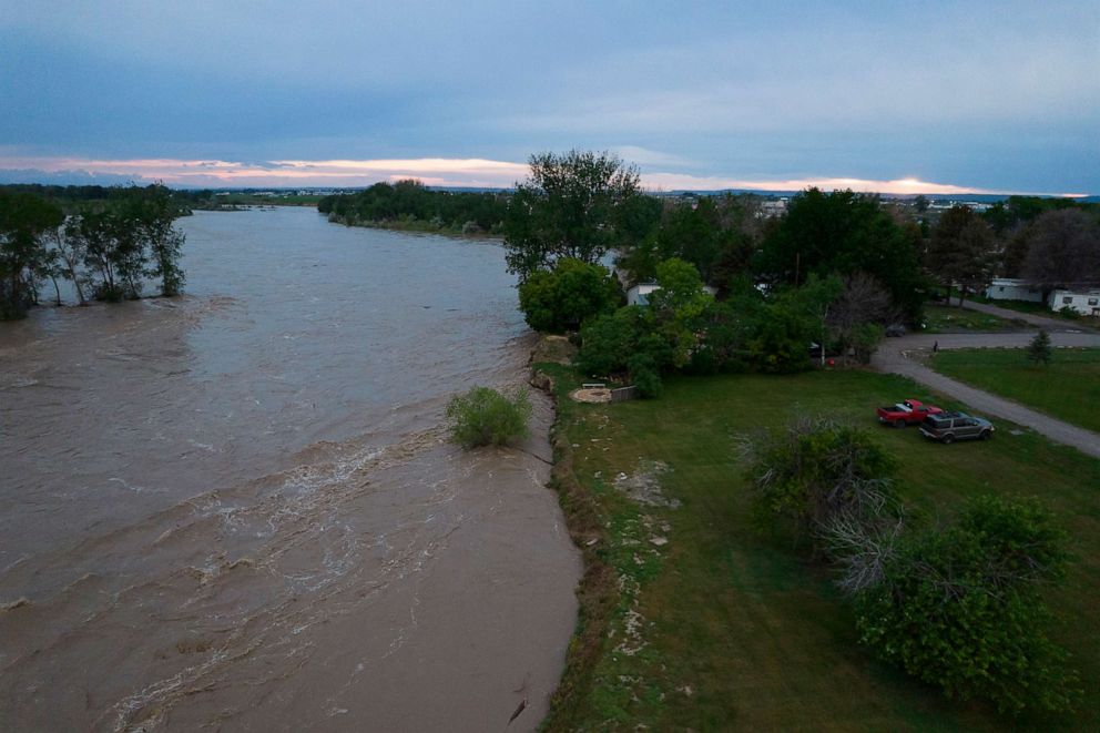 PHOTO: The roaring Yellowstone River is seen from the air sweeping over trees and near homes, June 14, 2022, in Billings, Mont.