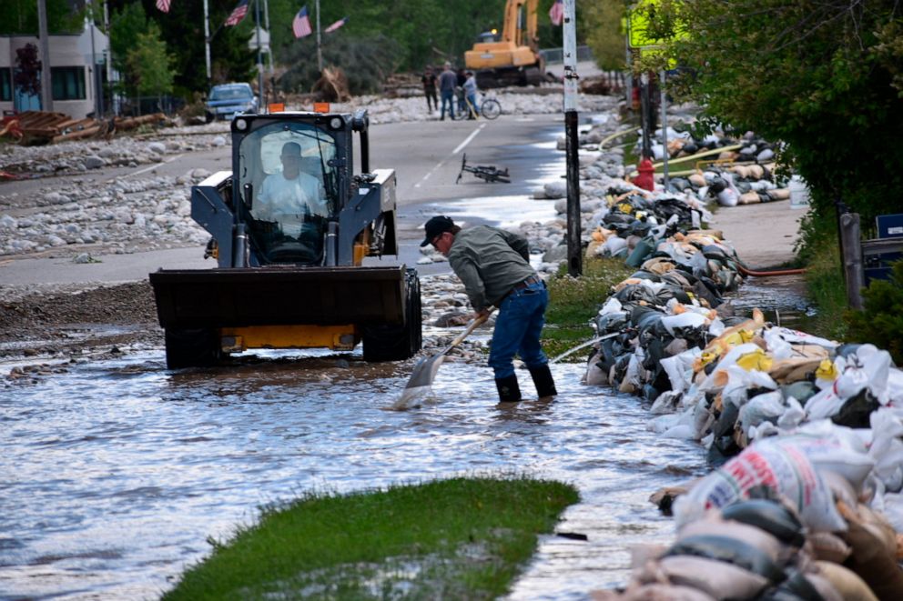 PHOTO: Residents of Red Lodge, Montana, are seen clearing mud, water and debris from the small city's main street, June 14, 2022.