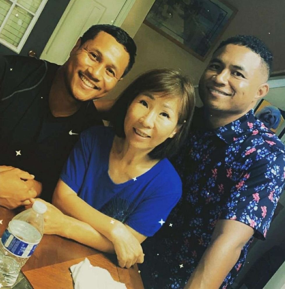 PHOTO: Yong Yue, 63, posing with her two sons, was killed March 16, 2021, in the shootings at a spa in Atlanta.