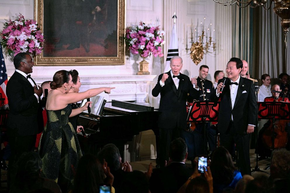 PHOTO: President Joe Biden and South Korean President Yoon Suk Yeol take the stage alongside singers at left, Norm Lewis, Jessica Vosk and Lea Salonga during a State Dinner at the White House, April 26, 2023.