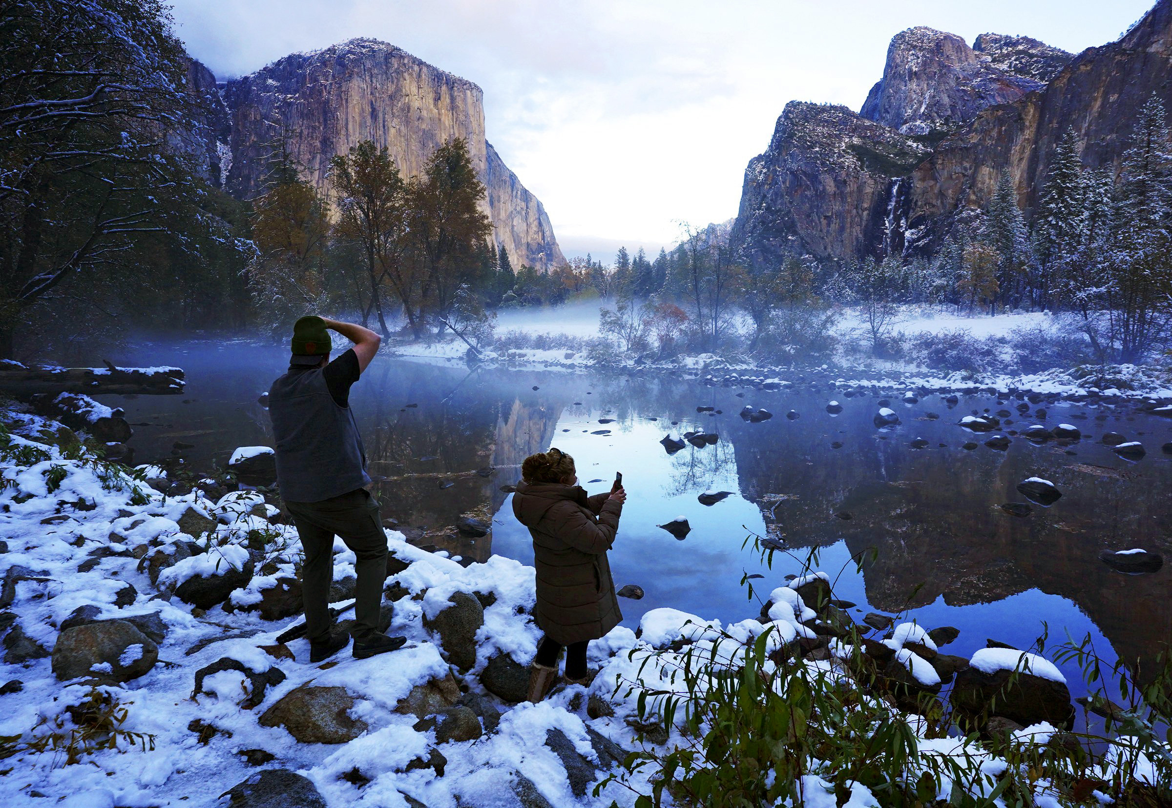 PHOTO: Erick Jensen, left, of Seattle, and Ruth Reyes, right, of Los Angeles, prepare to photograph the sunset in Yosemite Valley, Nov. 9, 2020, following a snowstorm in Yosemite National Park, Calif.