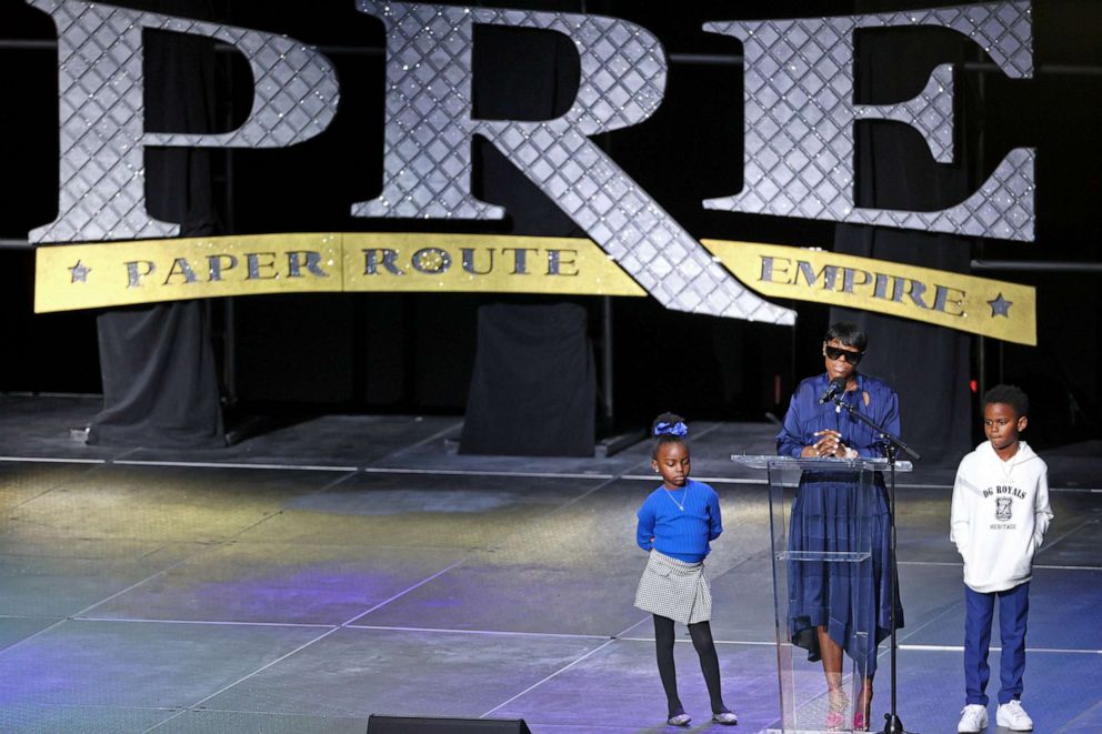 PHOTO: Young Dolph's long time partner Mia Jaye and their children Tre Tre and Ari speak to the crowd gathered during a celebration of life tribute for late rapper at FedExForum on Dec. 16, 2021 in Memphis, Tenn.
