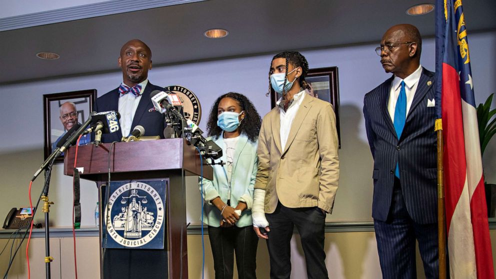 PHOTO: Attorney Mawuli Davis, left, speaks on behalf of Taniyah Pilgrim, center, and Messiah Young, right, during a press conference by the Fulton County District Attorney's Office in Atlanta, June 2, 2020.