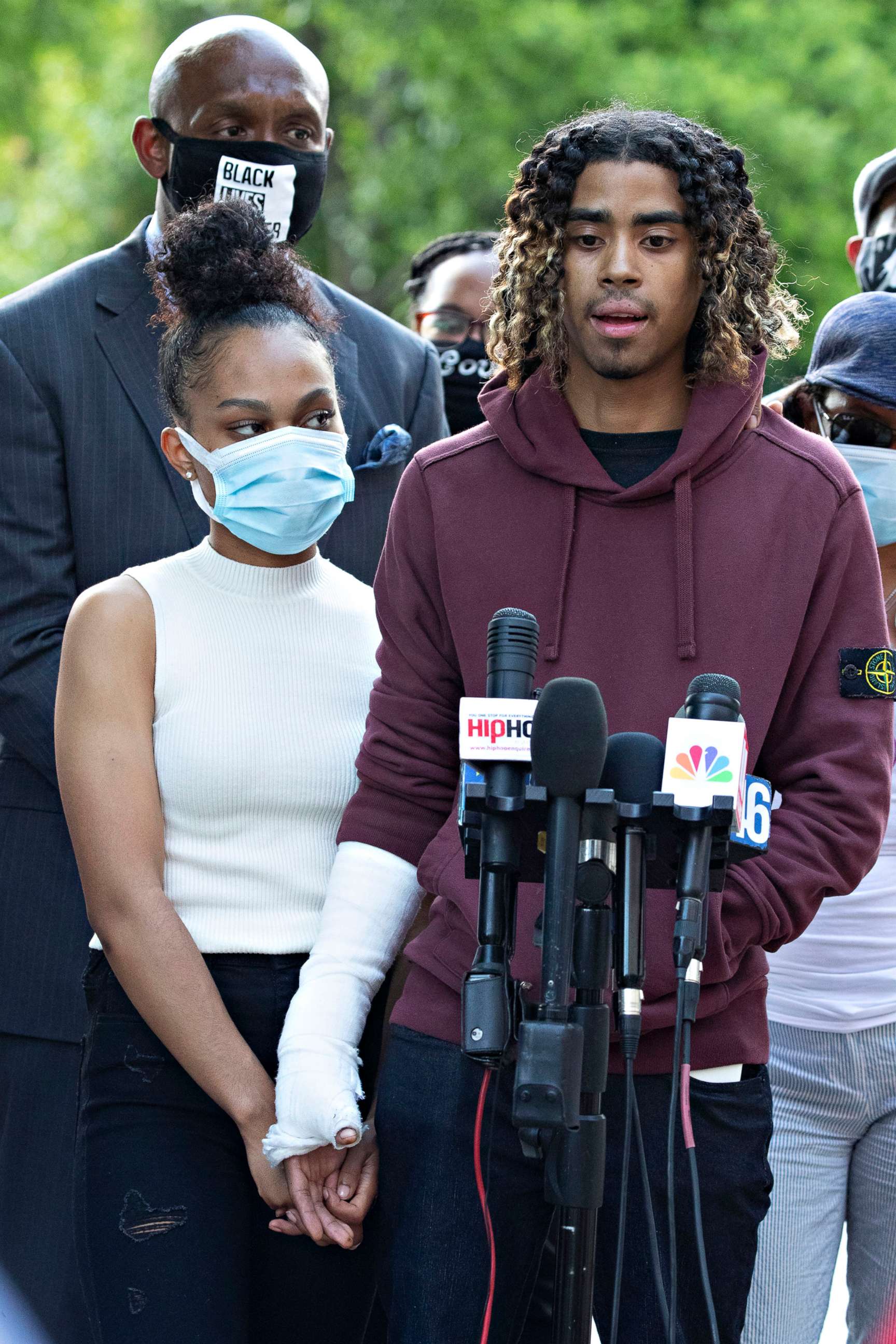 PHOTO: Taniyah Pilgrim holds Messiah Young's bandaged hand as he speaks during a news conference on the campus of Morehouse College, June 1, 2020, in Atlanta.