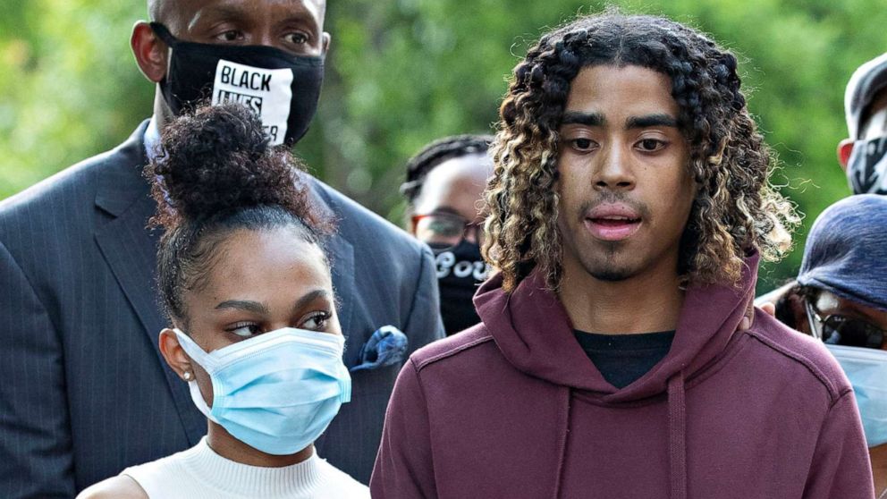 PHOTO: Taniyah Pilgrim holds Messiah Young's bandaged hand as he speaks during a news conference on the campus of Morehouse College, June 1, 2020, in Atlanta.