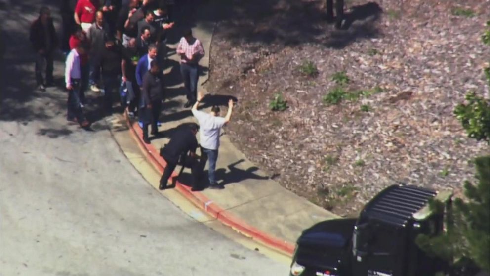 PHOTO: Police officers seen patting down people outside after they exited YouTube headquarters in San Bruno, California, after reports of an active shooter.