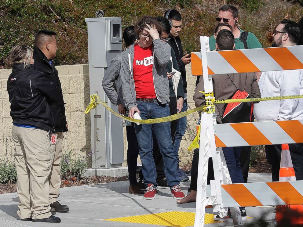 PHOTO: People wait to be escorted into a YouTube office building in San Bruno, Calif., April 4, 2018.