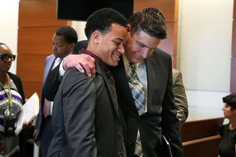 Zachary Cruz is hugged by Mike Donovan, CEO of Nexus Services, Inc., at the Broward County Courthouse, May 11, 2018 in Fort Lauderdale, Fla.