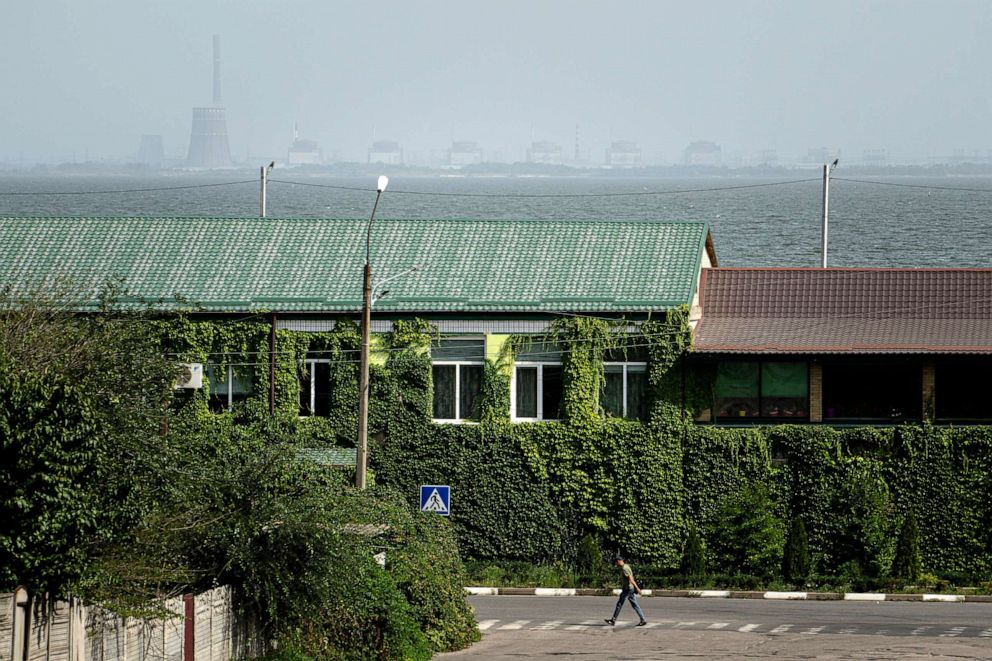 PHOTO: A man walks on a pedestrian crossing point near the Dnipro river and Zaporizhzhya nuclear plant on the other side in Nikopol, Ukraine, Aug, 22, 2022.