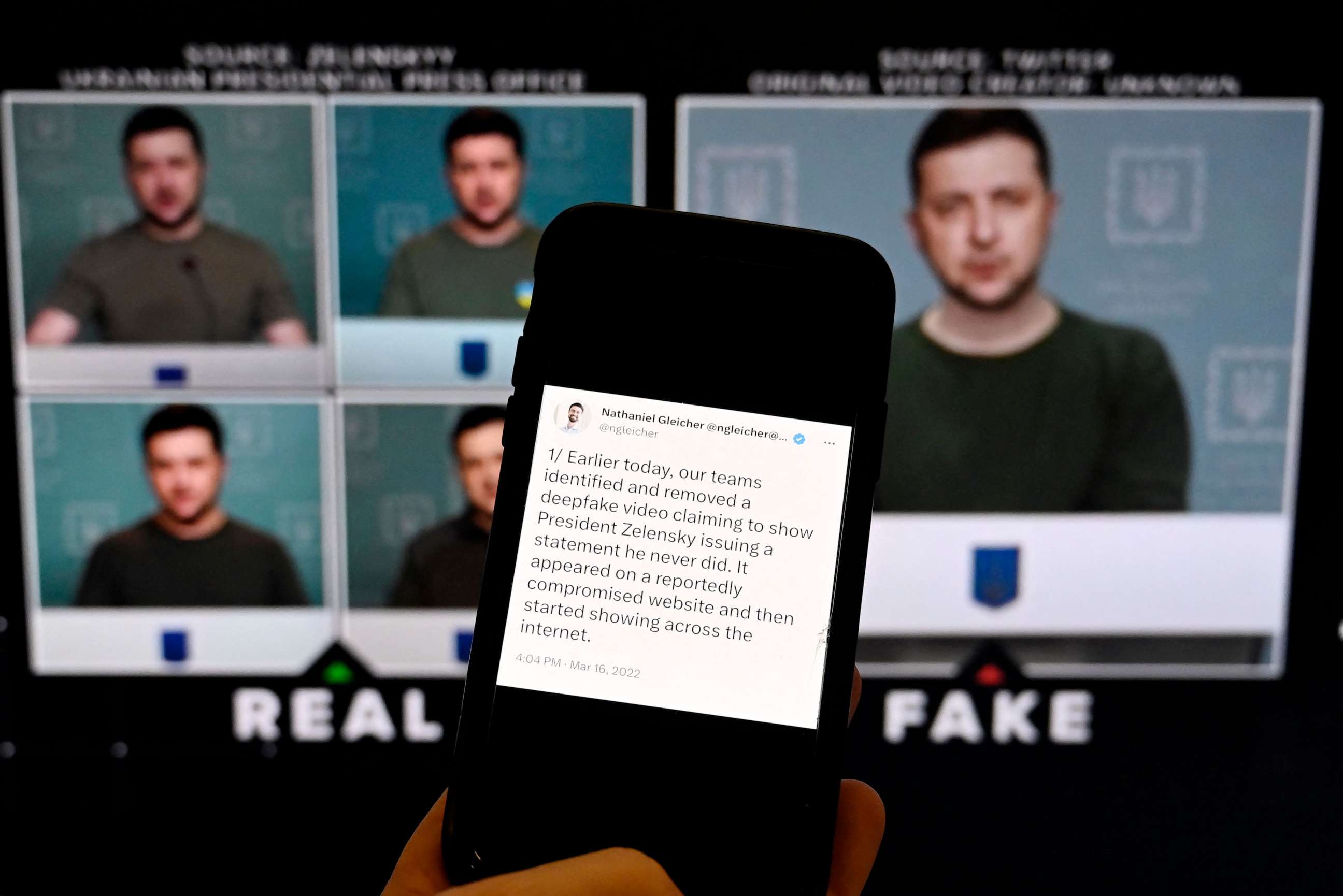 PHOTO: This photo shows a phone screen displaying a statement from the head of security policy at META with a fake video of Ukrainian President Zelensky calling on his soldiers to lay down their weapons shown in the background, in Washington, DC.