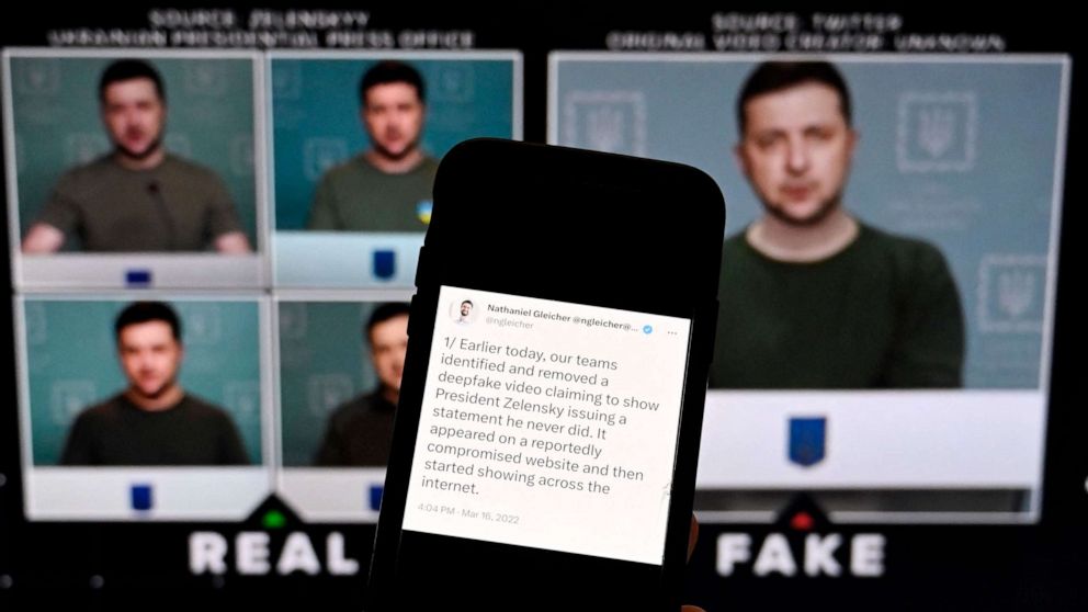 PHOTO: This photo shows a phone screen displaying a statement from the head of security policy at META with a fake video of Ukrainian President Zelensky calling on his soldiers to lay down their weapons shown in the background, in Washington, DC.