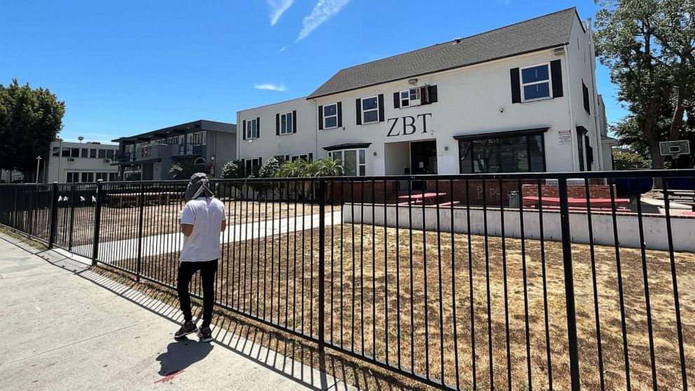 PHOTO: A man walks by the Zeta Beta Tau fraternity house on W 28th Street, 'Frat Row,' on Aug. 12, 2022, in Los Angeles.