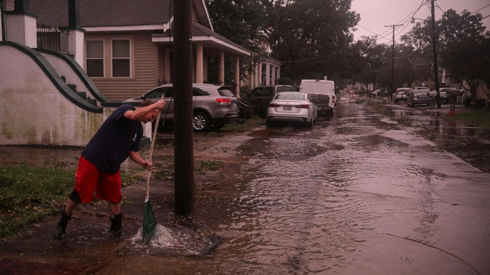 PHOTO: A resident clears storm drains after the eye of Hurricane Zeta passes over on Oct. 28, 2020, in Arabi, La. A record seven hurricanes have hit the Gulf Coast in 2020, bringing prolonged destruction to the area.