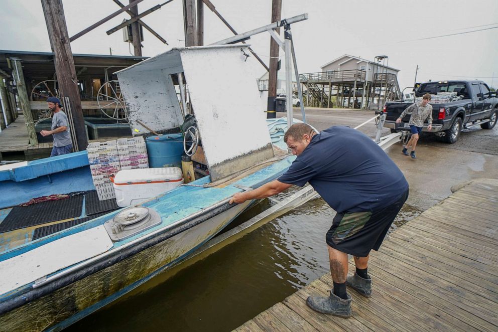 PHOTO: Shrimpers secure their boat on a trailer to bring to higher ground as Hurricane Zeta approaches on Oct. 28, 2020, in Shell Beach, La.