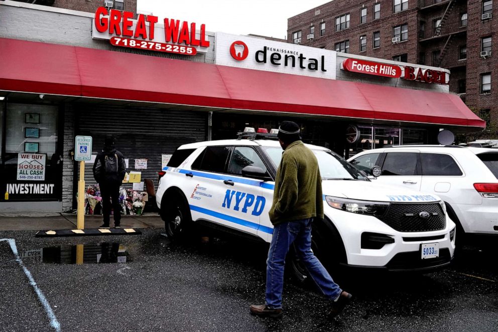 A NYPD patrol vehicle stands outside a memorial for Zhiwen Yan, a 45 year old Chinese immigrant fatally shot and killed on April 30, at Great Wall, a Chinese restaurant where he worked, in the Forest Hills neighborhood of Queens, New York, May 2, 2022.