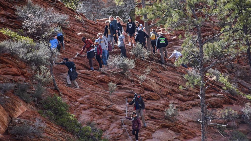 PHOTO: People crowd together while navigating a narrow hiking trail at Zion National Park in Utah, March 21, 2020, in a photo shared via Twitter by the National Park Service.