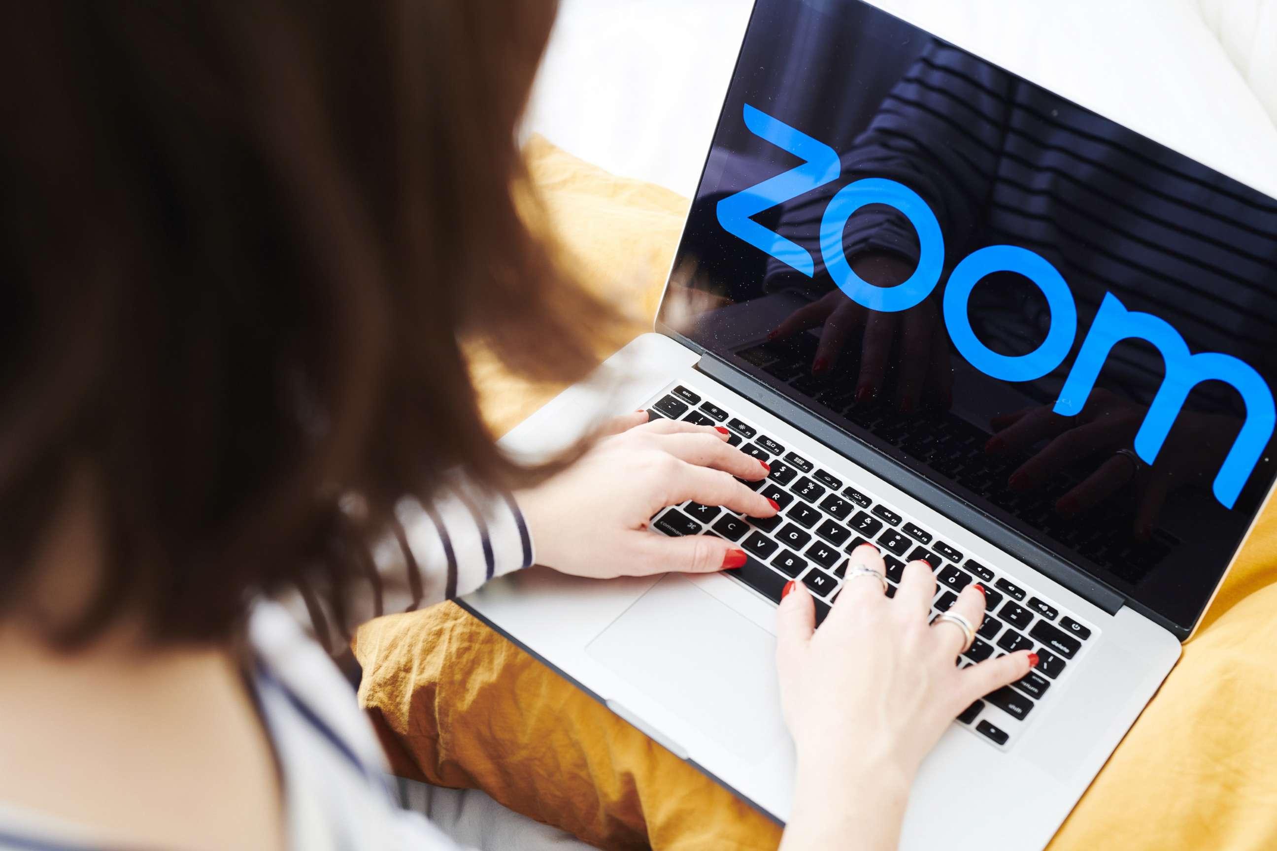 PHOTO: The logo for the Zoom Video Communications Inc. application is displayed on an Apple Inc. laptop computer in an arranged photograph taken in the Brooklyn, N.Y., April 10, 2020.