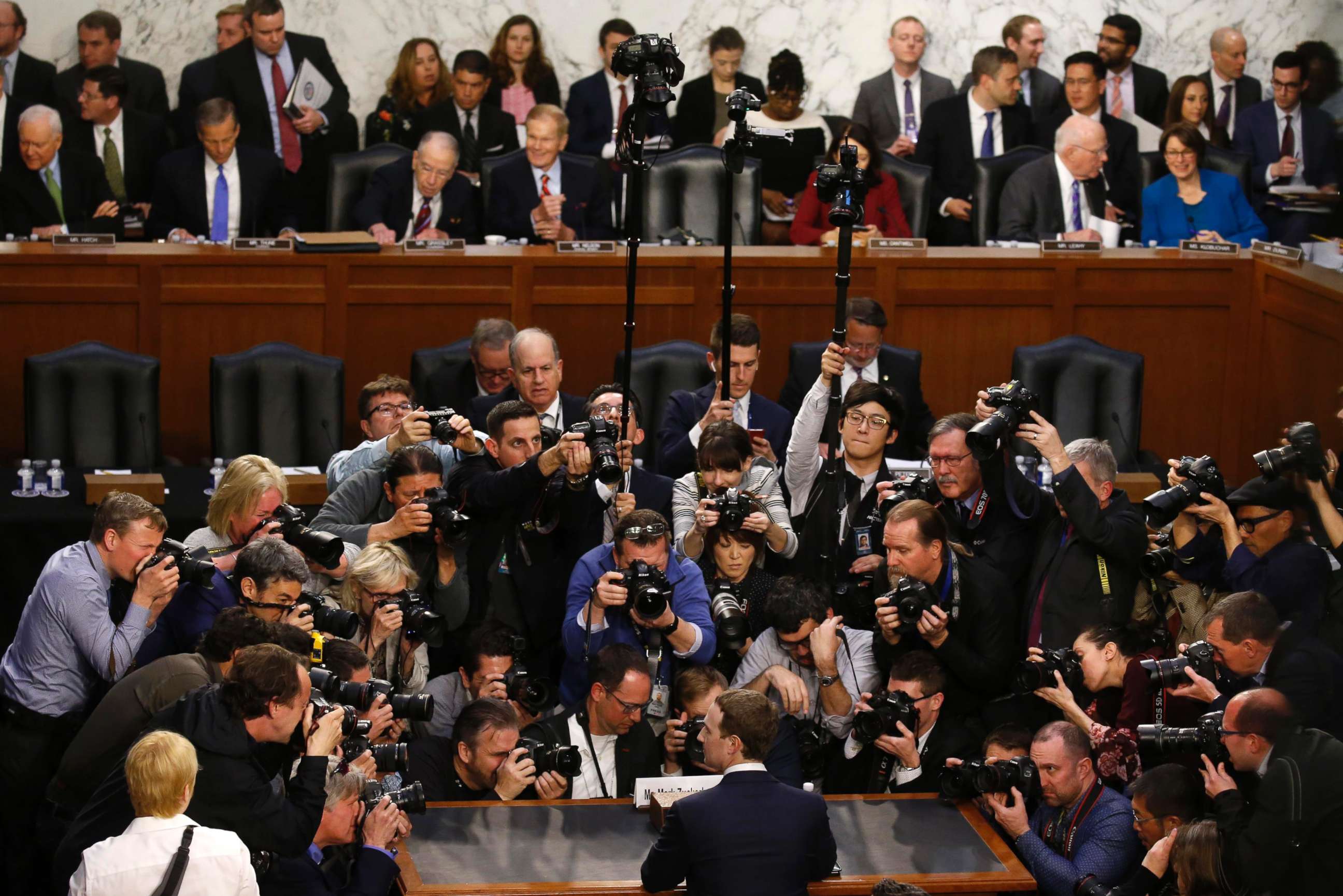 Facebook CEO Mark Zuckerberg is surrounded by members of the media during his appearance before a Senate Judiciary and Commerce Committees joint hearing on Capitol Hill in Washington, April 10, 2018. 