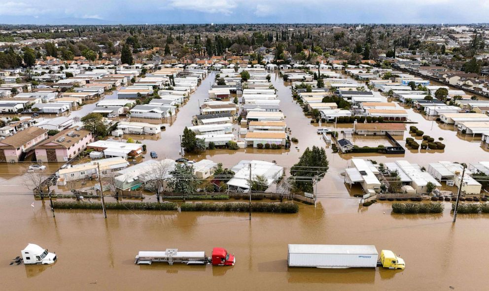 PHOTO: Trucks and homes are partially submerged in a flooded neighborhood in Merced, Calif. on Jan. 10, 2023.