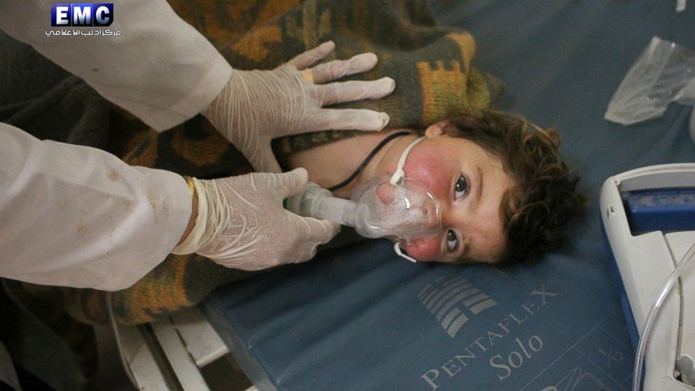 This photo provided, April 4, 2017, shows a Syrian doctor treating a child following a suspected chemical attack, at a makeshift hospital, in the town of Khan Sheikhoun, northern Idlib province, Syria. 
