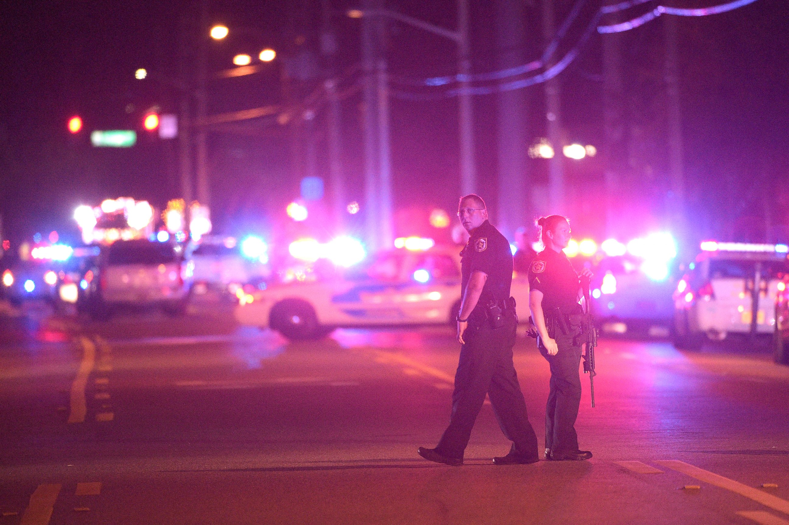 PHOTO: Police officers stand guard down the street from the scene of a shooting involving multiple fatalities at a nightclub in Orlando, Fla., June 12, 2016.
