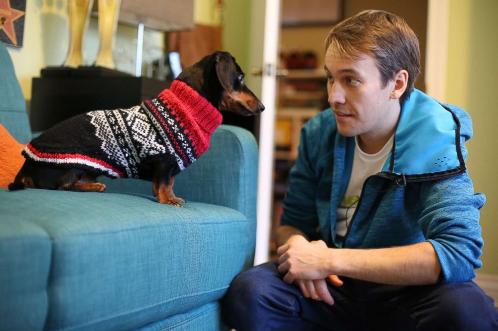 PHOTO: Ryan Beauchesne talks to his celebrity pup, Crusoe, at their home outside of Ottawa, Canada.