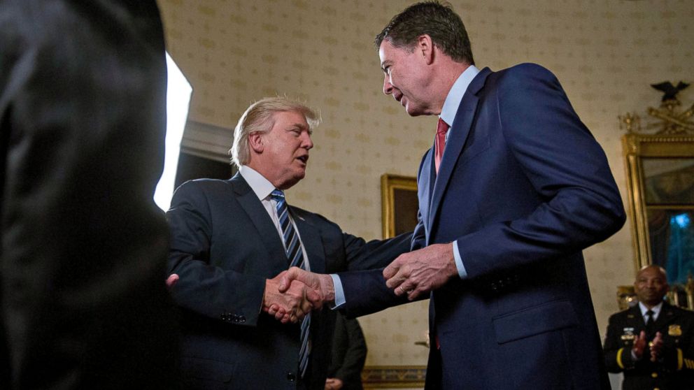 President Donald Trump shakes hands with James Comey, director of the Federal Bureau of Investigation (FBI), during an Inaugural Law Enforcement Officers and First Responders Reception in the Blue Room of the White House, Jan. 22, 2017.