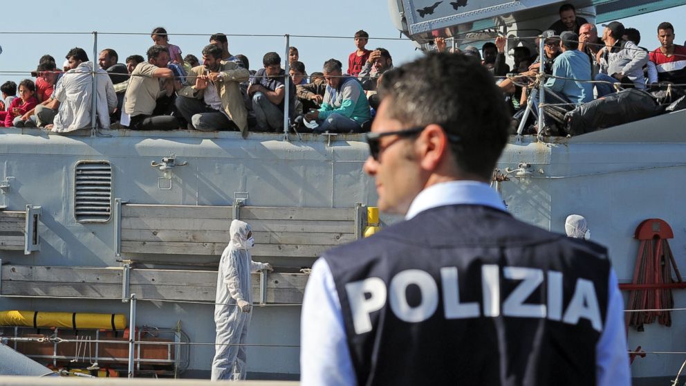 PHOTO: A policeman waits near the Italian military ship "Chimera," with around 350 would be immigrants on board
