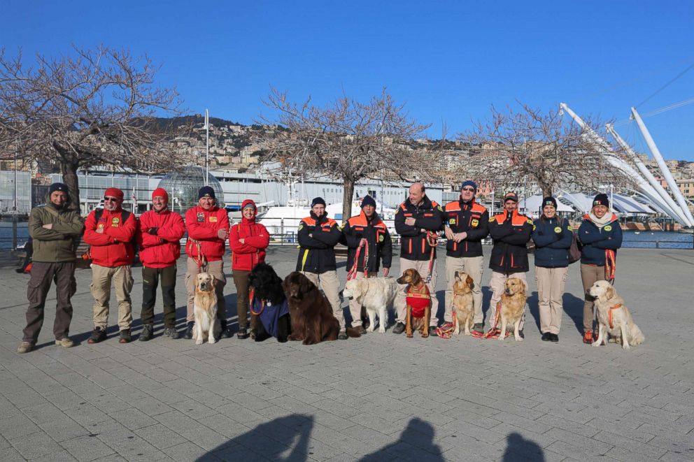 PHOTO: Handlers and their dogs pose after completing their rescue exercise in Genoa, Italy