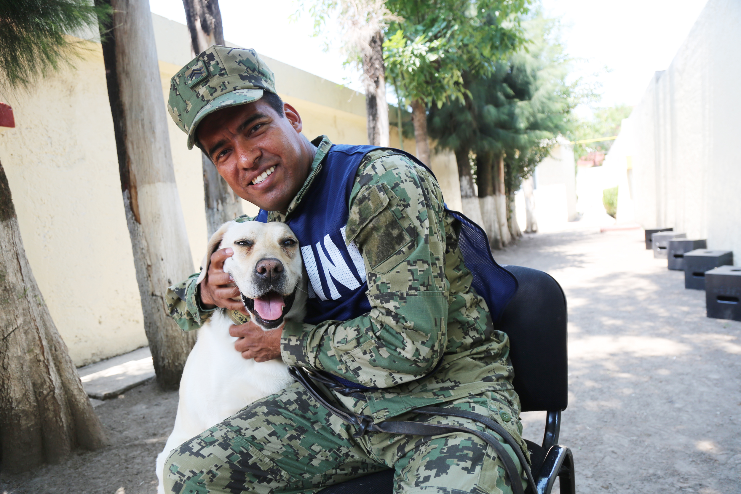 PHOTO: Israel Arauz Salinas hugs rescue dog Frida, who is his partner at the Mexican Navy Canine Unit. 