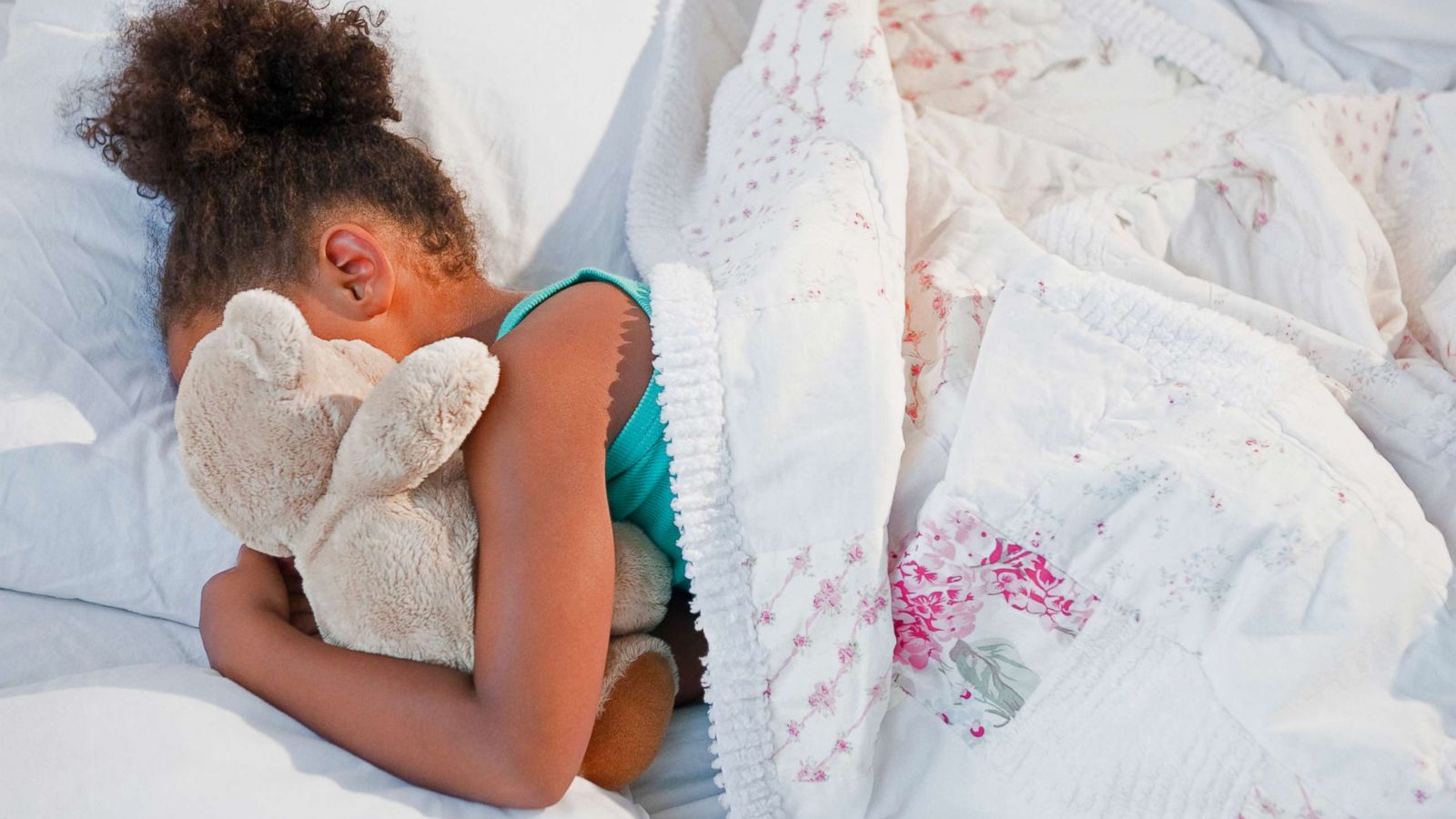 PHOTO: A girl sleeps with a teddy bear in this undated stock photo.