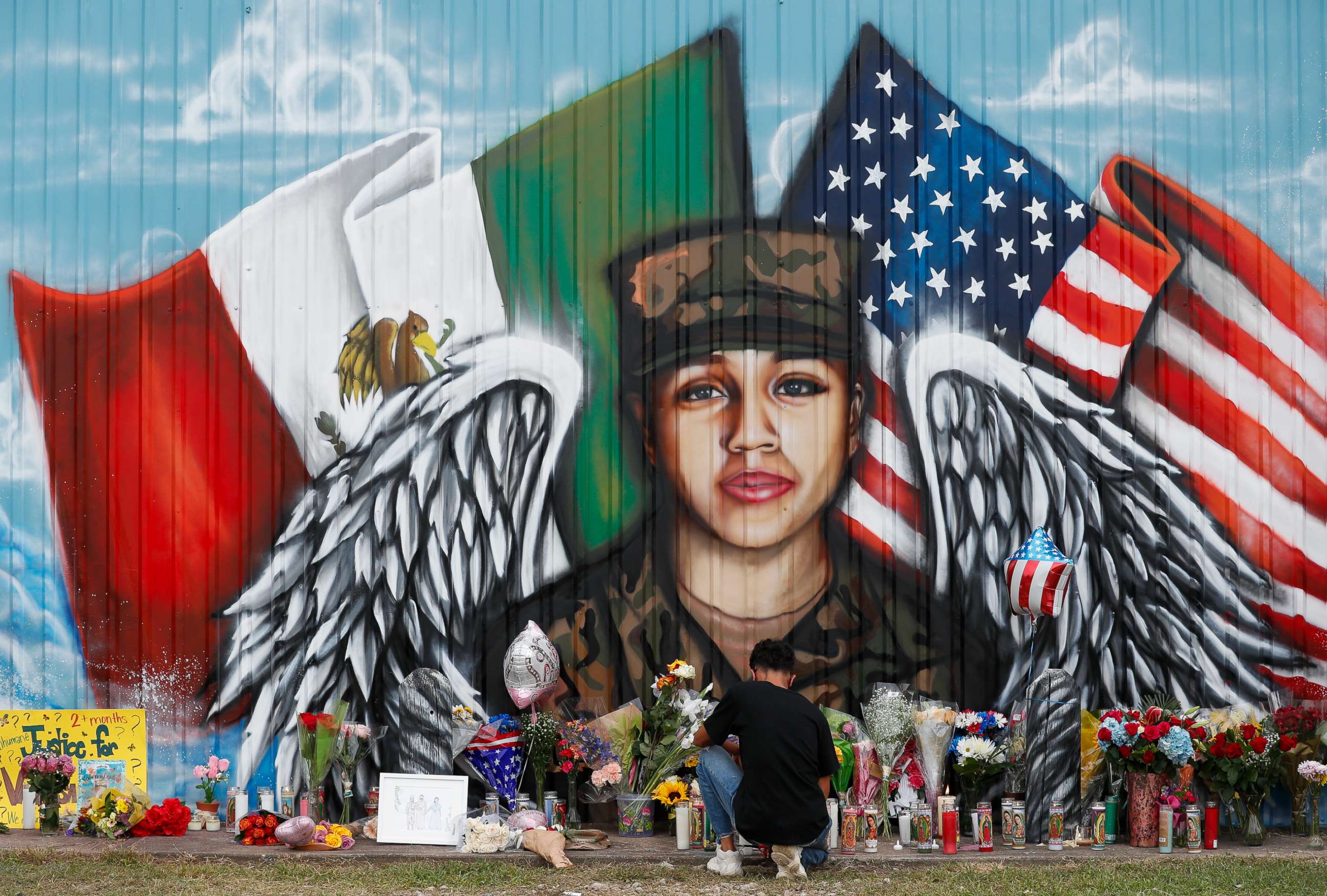 PHOTO: Juan Cruz, boyfriend of Army soldier Vanessa Guillen, kneels in front of a mural honoring her Sunday, July 5, 2020, in Houston.