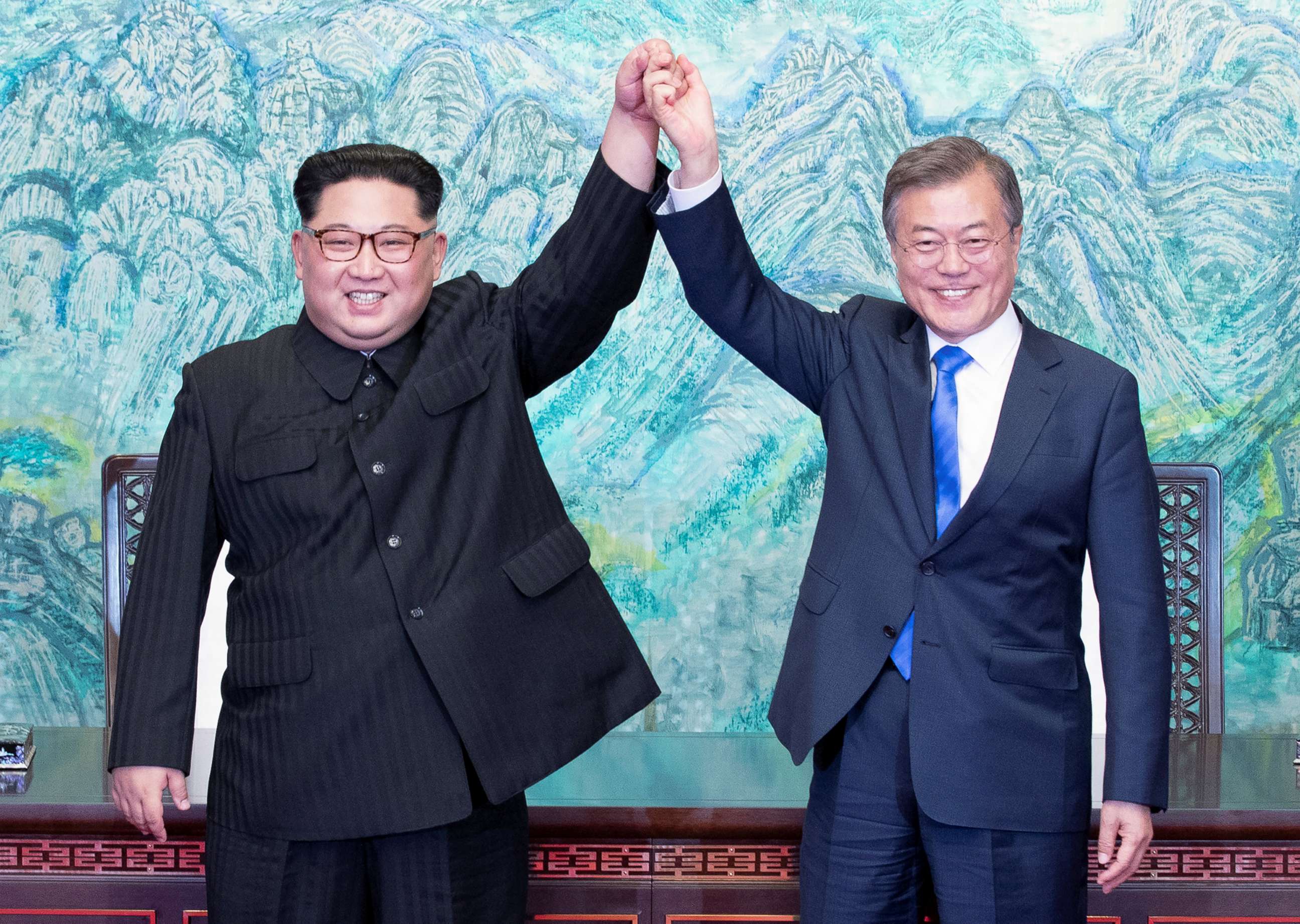 PHOTO: North Korean leader Kim Jong Un and South Korean President Moon Jae-in raise their hands at the truce village of Panmunjom inside the demilitarized zone separating the two Koreas, South Korea, April 27, 2018.