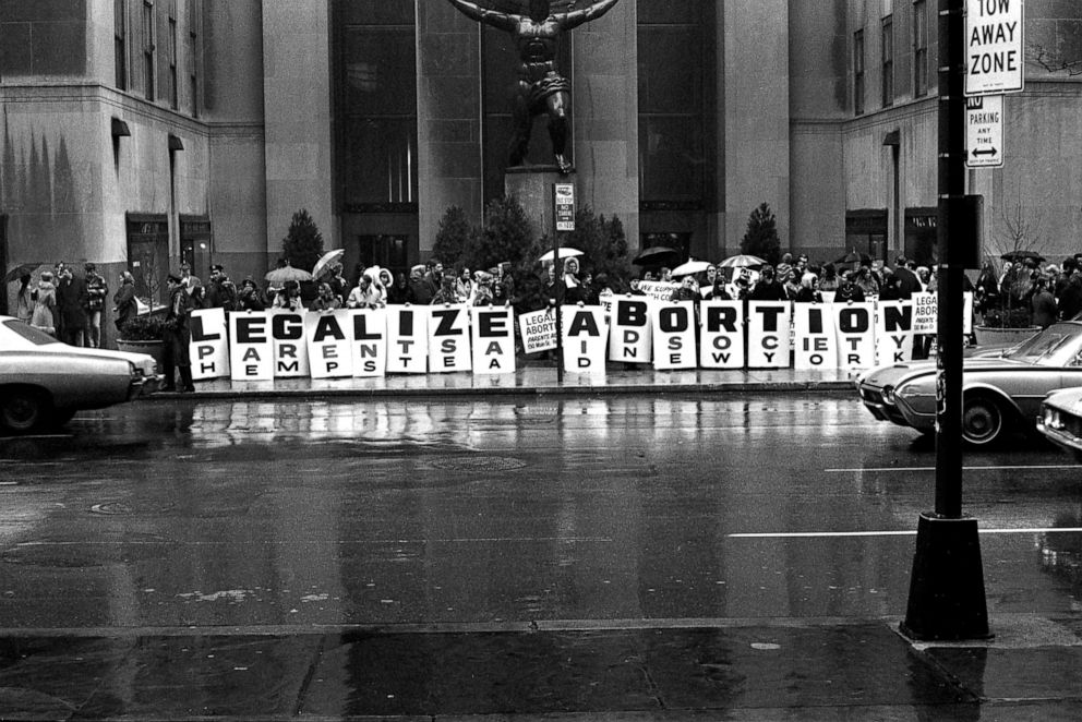 PHOTO: In front of the Atlas sculpture at Rockefeller Center, activists hold a series of signs that read 'Legalize Abortion' during a demonstration in New York, March 1968. 