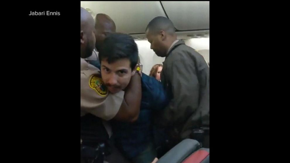 Video Chaos aboard flight as police use stun gun to arrest, remove ...