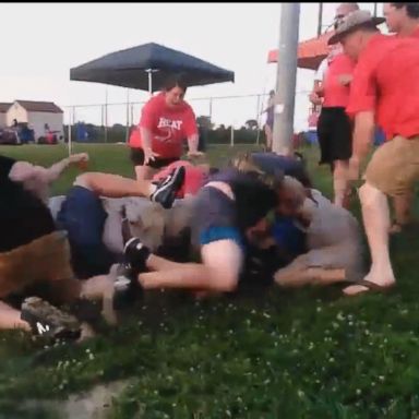 Cell phone video shows parents breaking out into a brawl during a softball tournament, resulting in both teams' being kicked off the field.