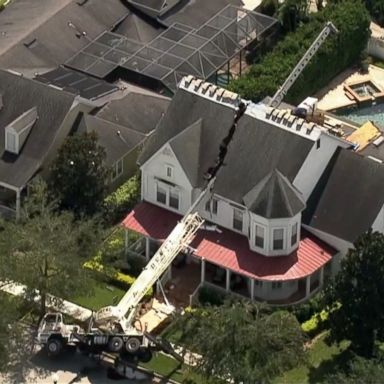 The giant crane toppled over, cutting the house in half.