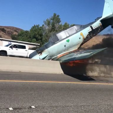 The pilot was not injured after the plane hit the center divider and burst into flames.