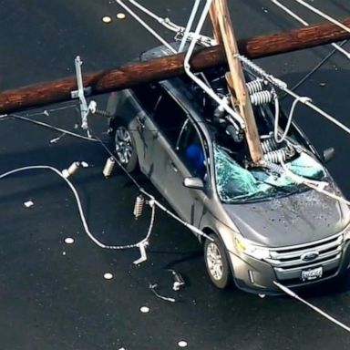 VIDEO: Downed power lines leave 2 people trapped in car