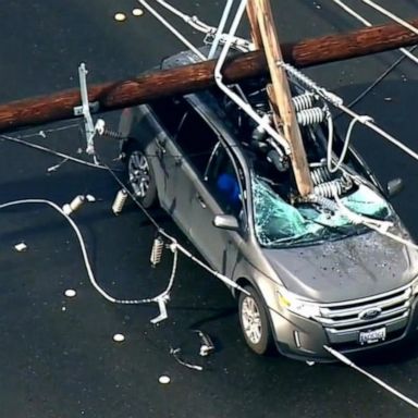 VIDEO: Couple survives after electrical pole slams into their car