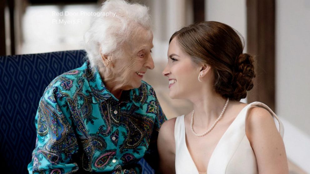 Grandma in isolation sees granddaughter through glass door on wedding day -  ABC News