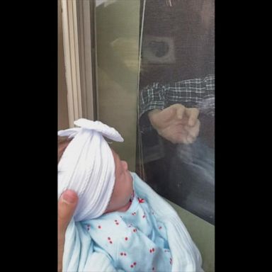 VIDEO: Couple introduces grandfather to baby through glass