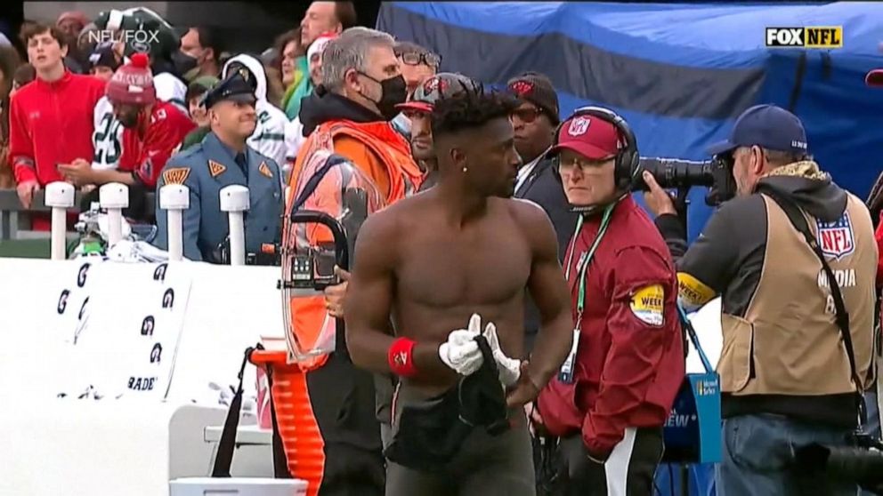 Antonio Brown strips his shirt off as he leaves Tampa Bay