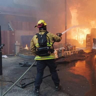 VIDEO: Firefighters race to contain LA wildfires as winds subside 